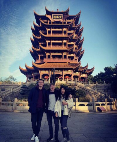 Christien Three people standing in front of Yellow Crane Tower in Wuhan, China