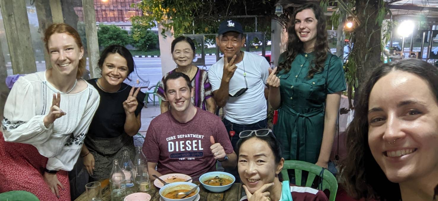group of people enjoying a meal together in Thailand