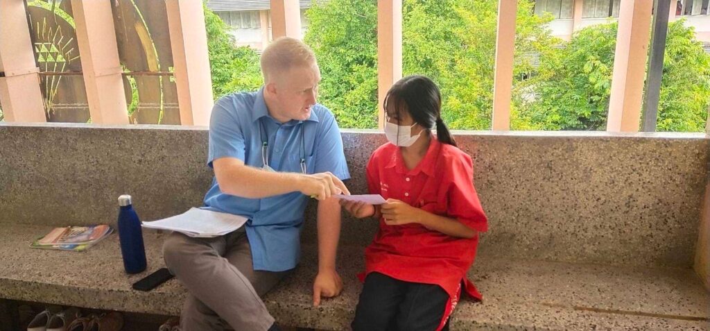 English teacher talking to a learner in Thailand 