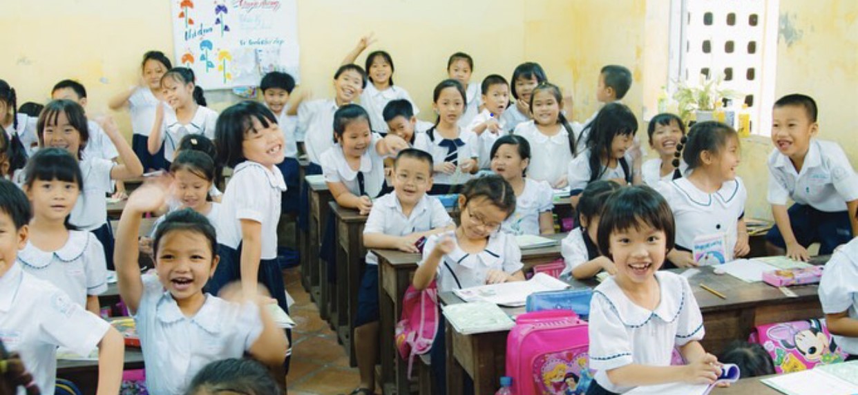 Classroom full of smiling students in Asia