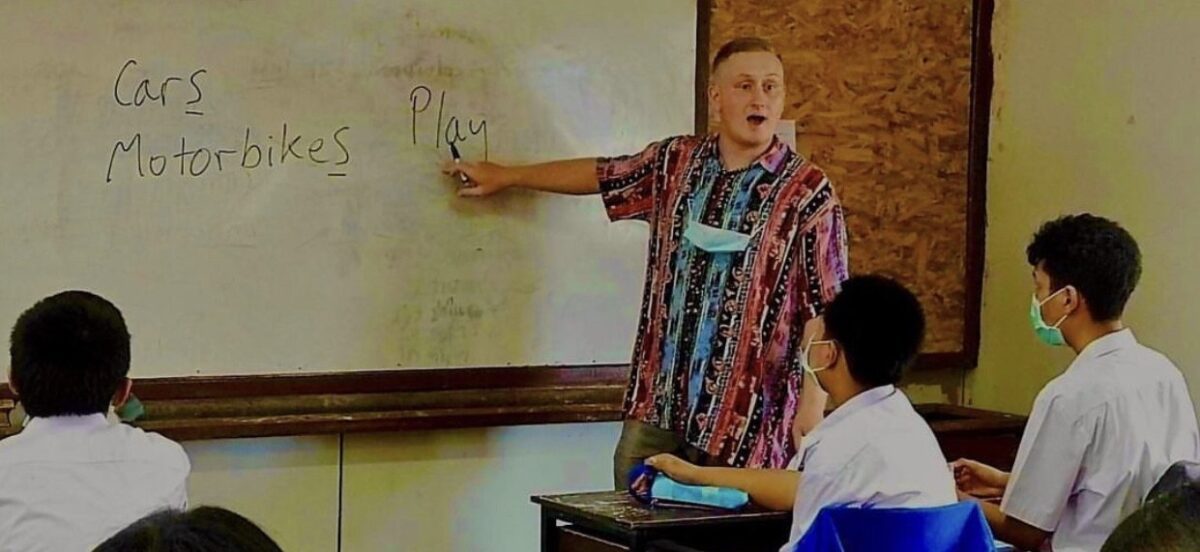 English teacher in Thailand in front of a blackboard 