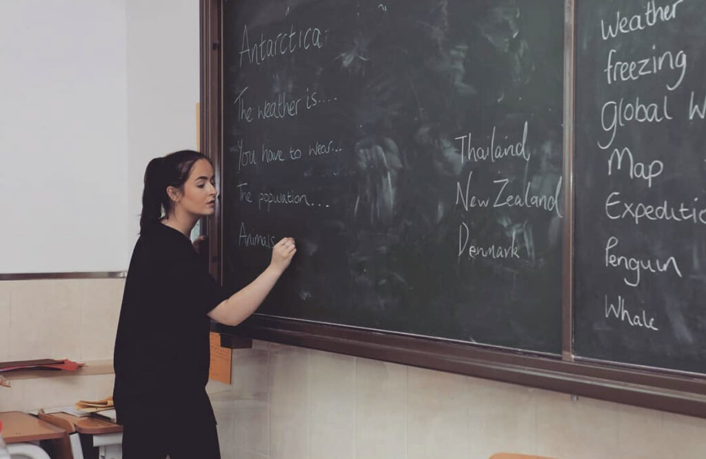 English teacher writing on the blackboard 