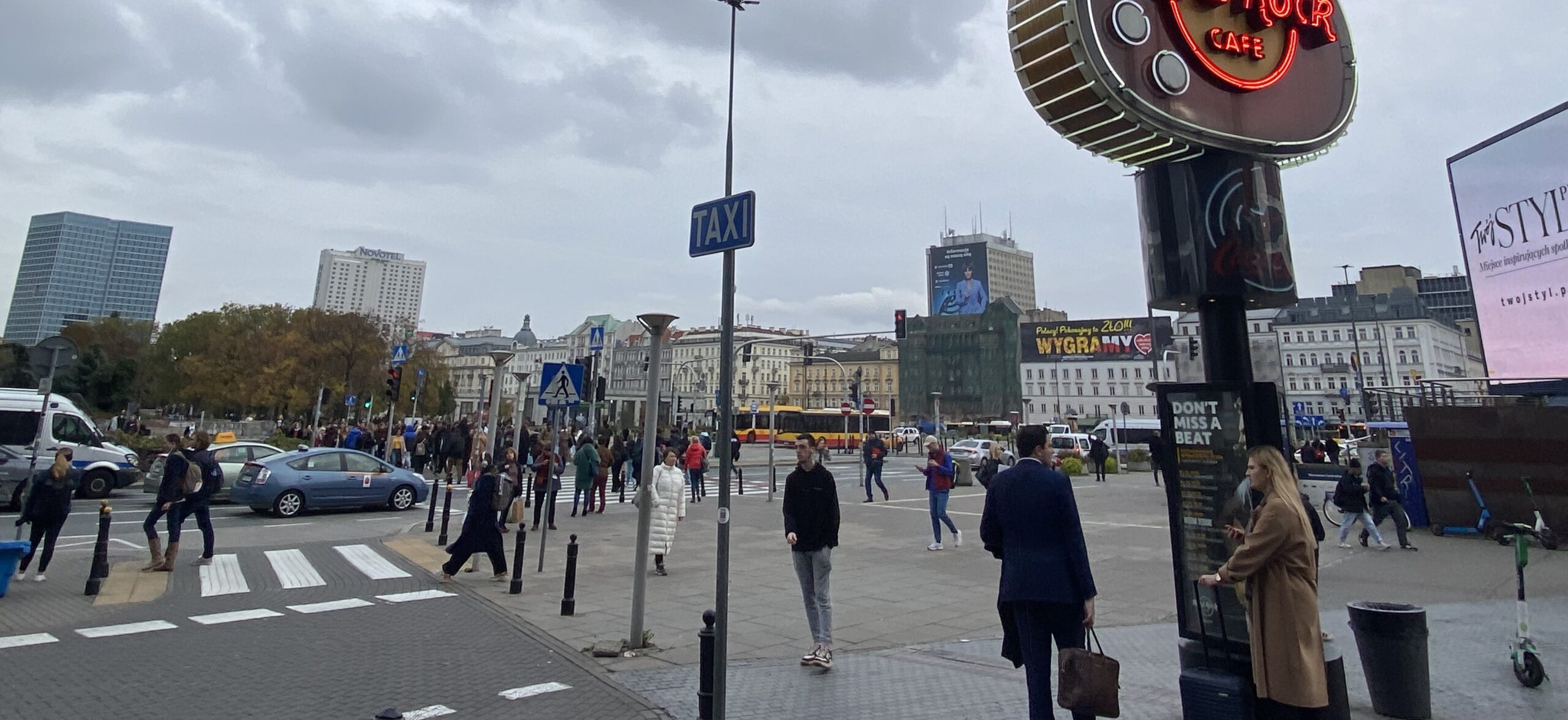Busy street in central Warsaw, full of cars and pedestrians