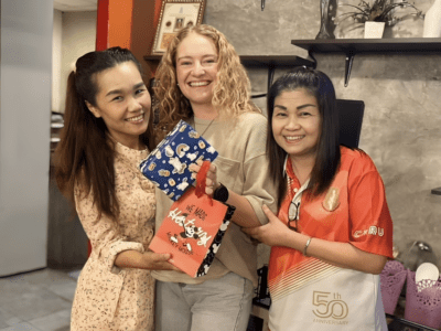 teacher standing in a classroom with Thai colleagues