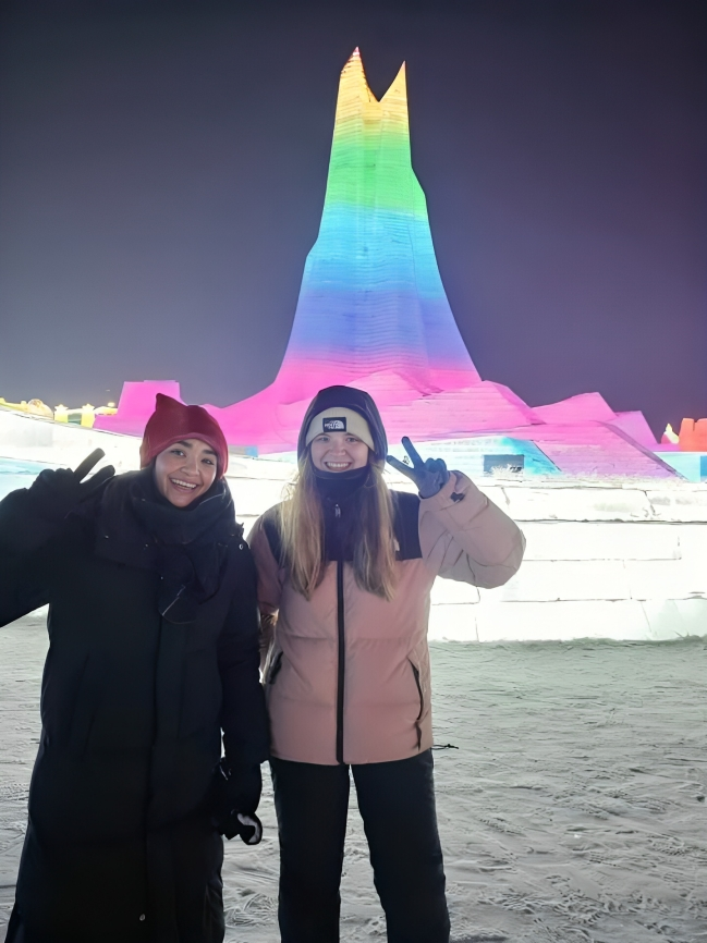 Two women smiling at the Harbin Ice Festival 