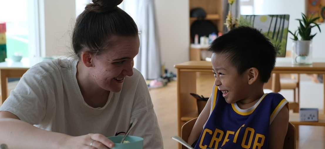 Teacher and her student smiling at each other